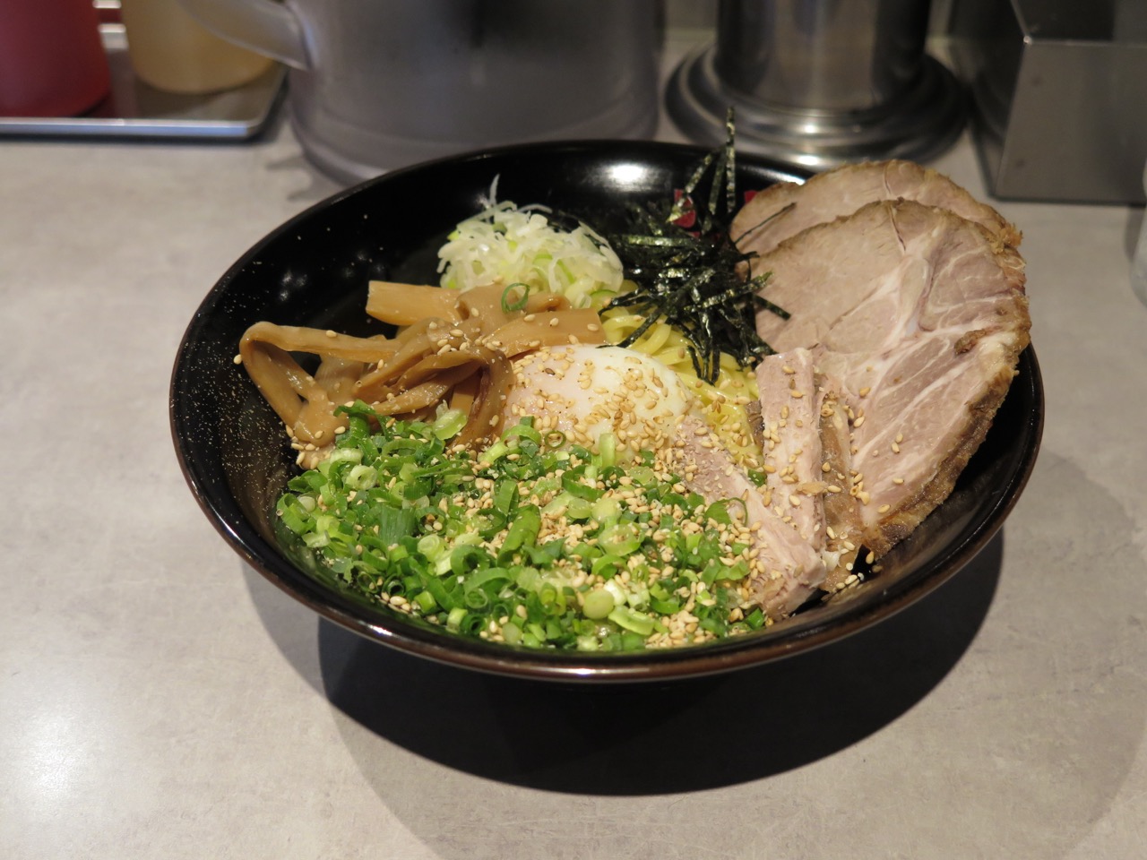 A bowl of abura soba with seasoned oil and sauce at the bottom, no broth
